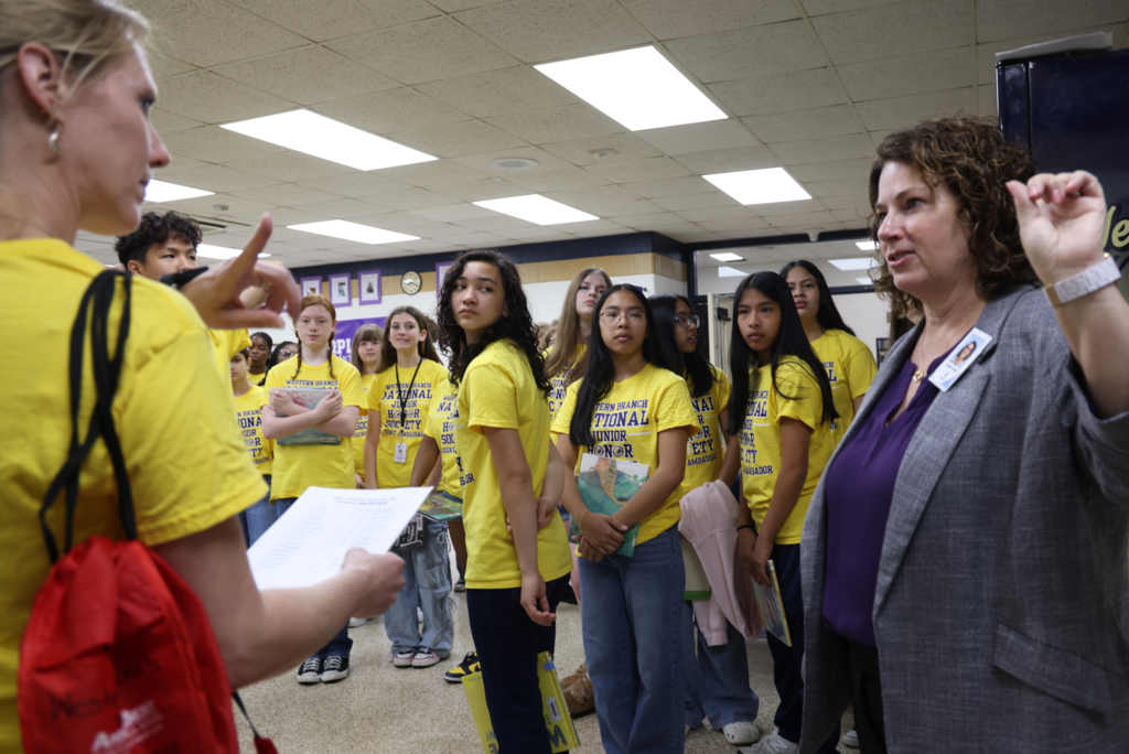 students excitedly prepare to read to  primary students