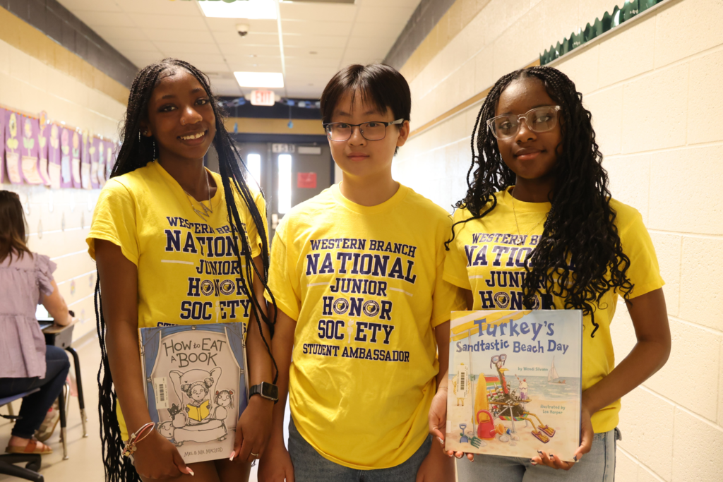 students excitedly prepare to read to  primary students