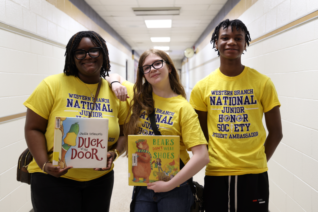 students excitedly prepare to read to  primary students