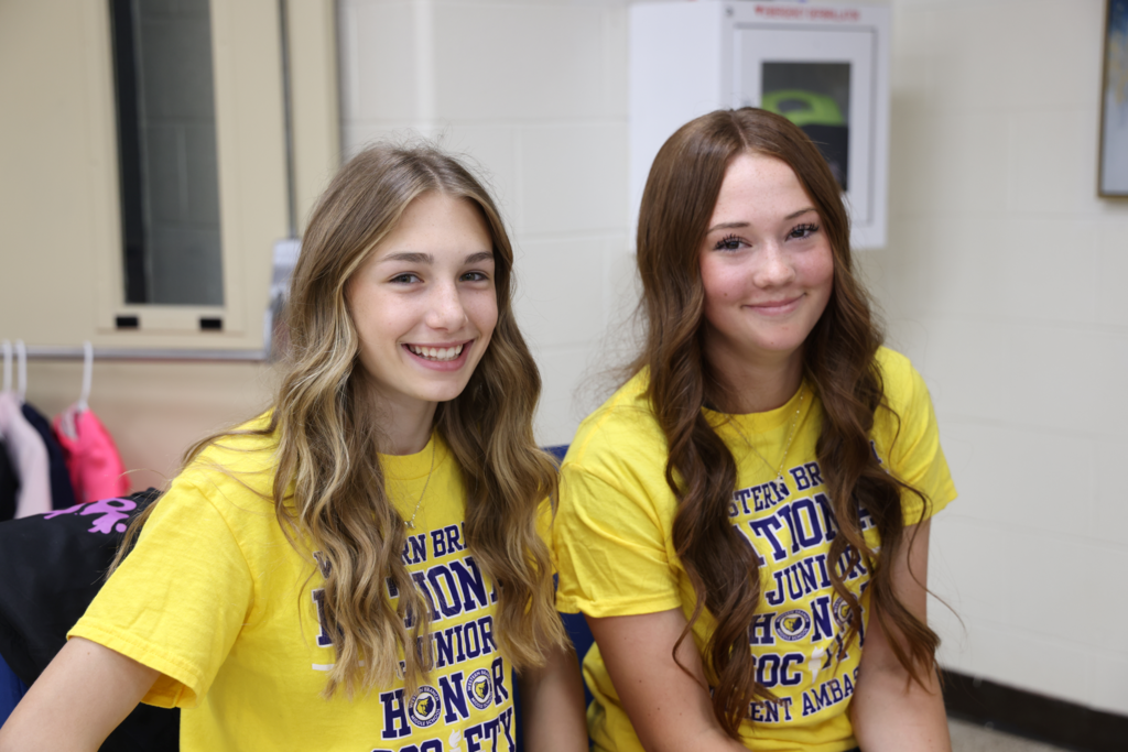 students excitedly prepare to read to  primary students