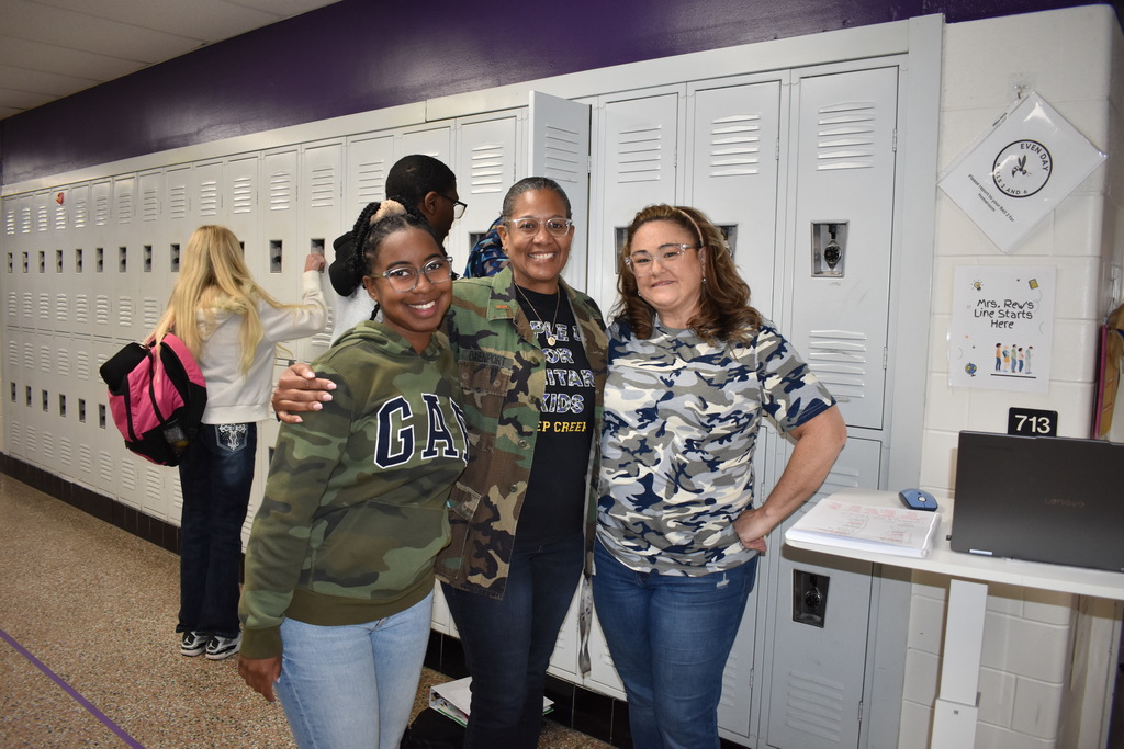 three teachers wearing camo to celebrate the month of the military child. 