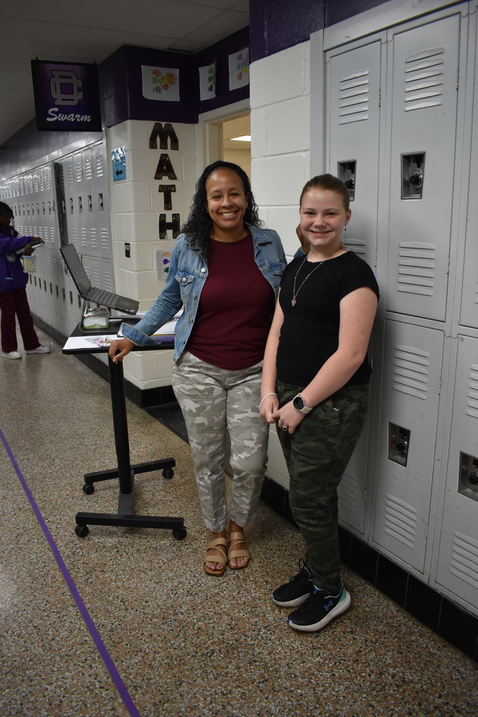 A student and teacher wearing camo to celebrate the month of the military child. 