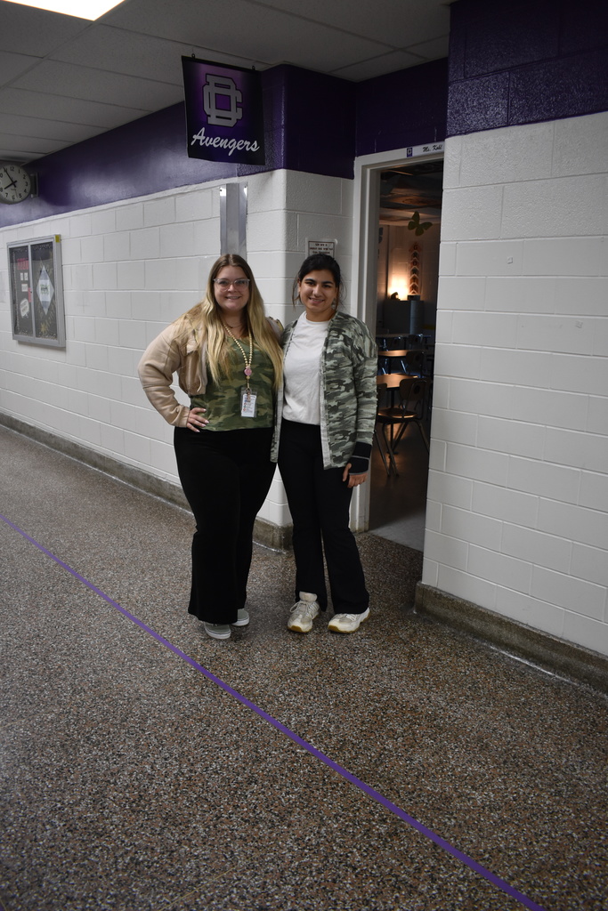 A student and teacher wearing camo to celebrate the month of the military child. 