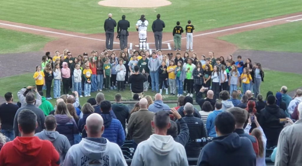 4th grade chorus sings the National anthem at the Tides baseball game