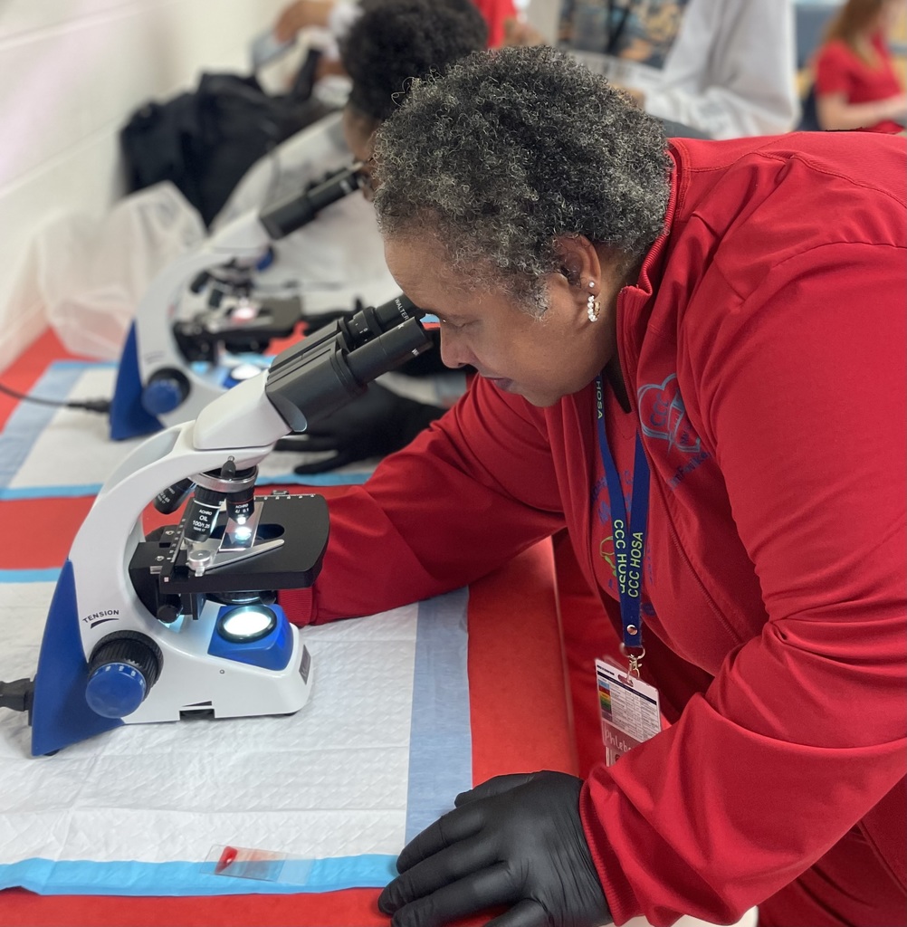 Teacher setting up the microscope