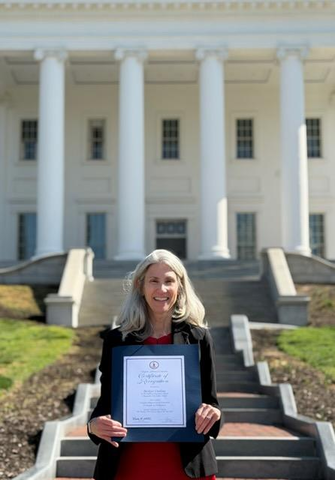 Bridget Outlaw celebrates with her award for Principal of Distinction