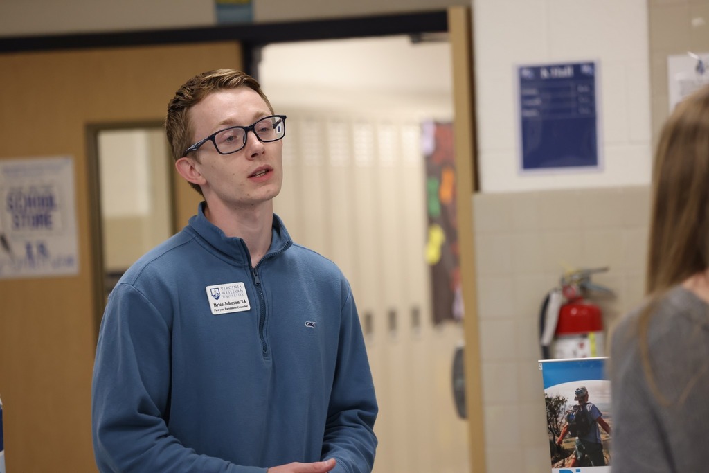 Parents, students, and community members eagerly speak to reps at the college fair