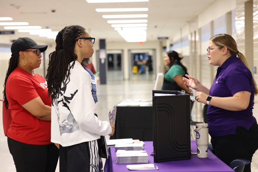 Parents, students, and community members eagerly speak to reps at the college fair
