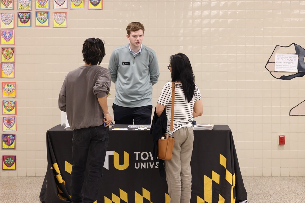 Parents, students, and community members eagerly speak to reps at the college fair