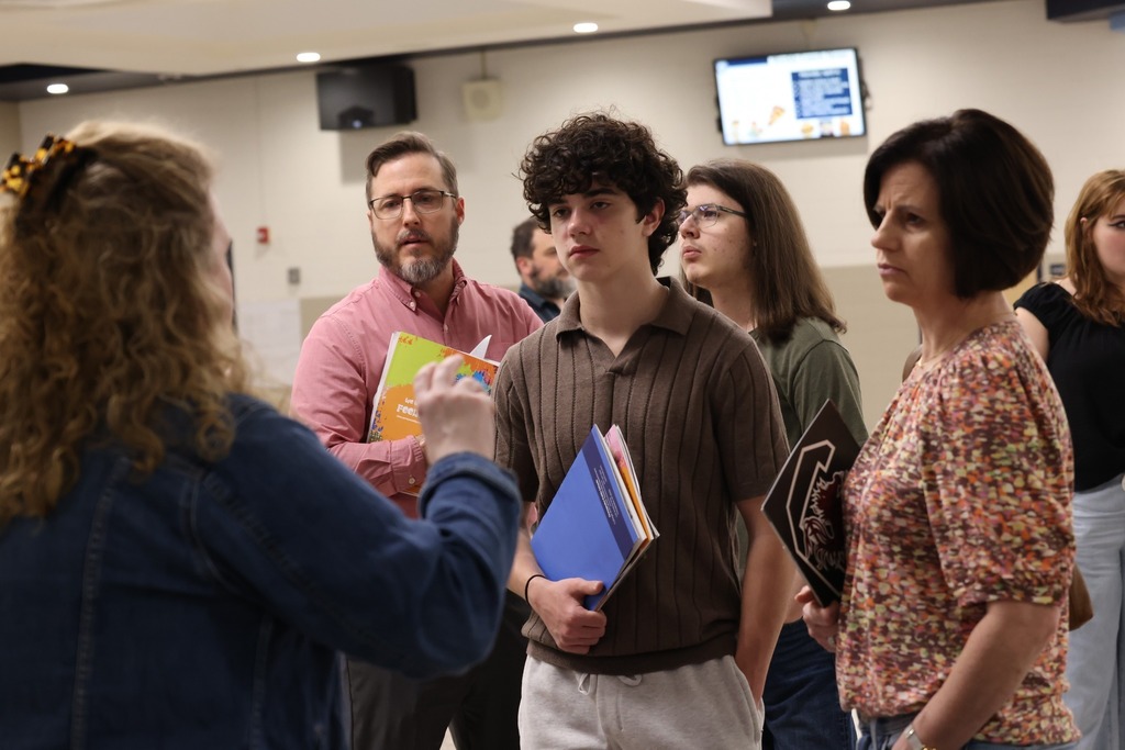 Parents, students, and community members eagerly speak to reps at the college fair