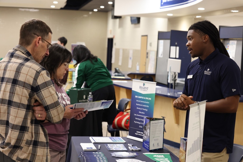 Parents, students, and community members eagerly speak to reps at the college fair