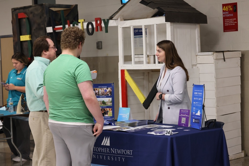 Parents, students, and community members eagerly speak to reps at the college fair
