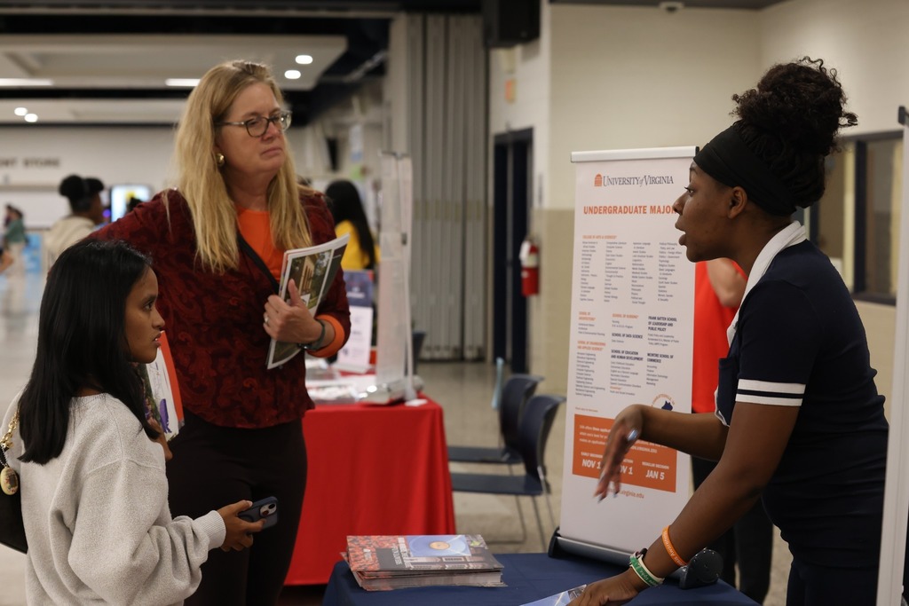 Parents, students, and community members eagerly speak to reps at the college fair