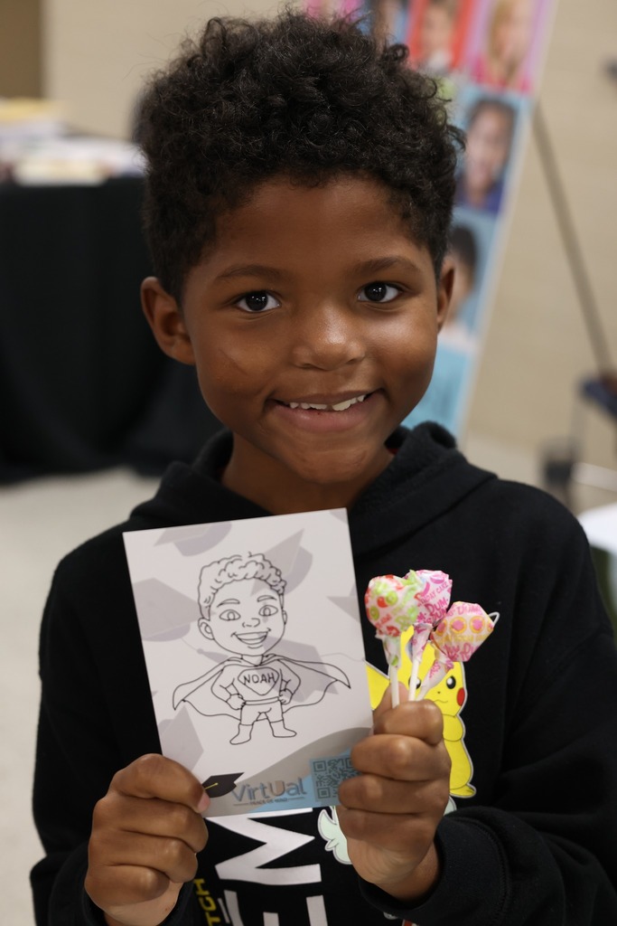 little attendee shows off his prizes from the college fair