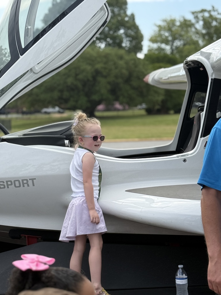 A student posing proudly beside the plane that visited GBP on Career Day.