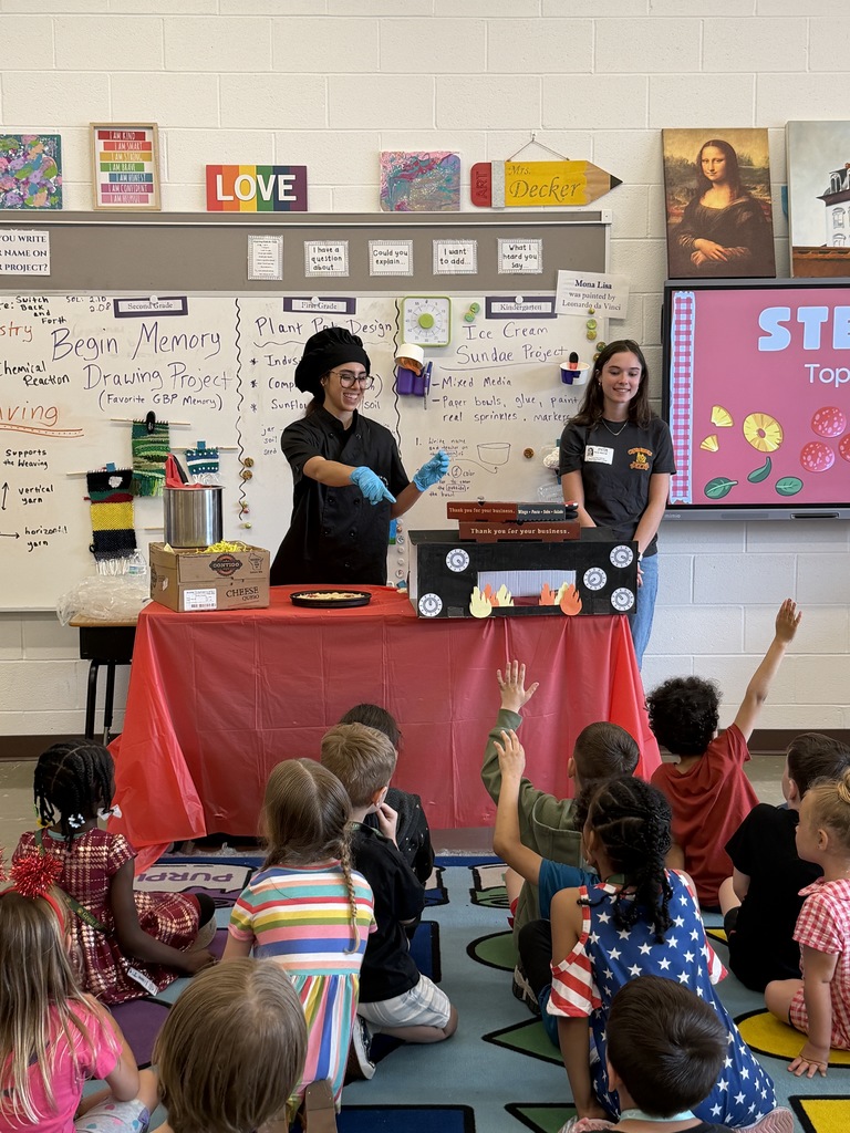 Employees from Chesapeake Pizza speaking to a class during Career Day, sharing about their jobs and daily responsibilities while students listen attentively.