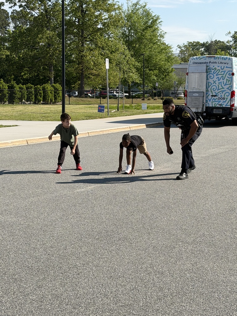 Sheriff and two students gearing up to race on Career Day