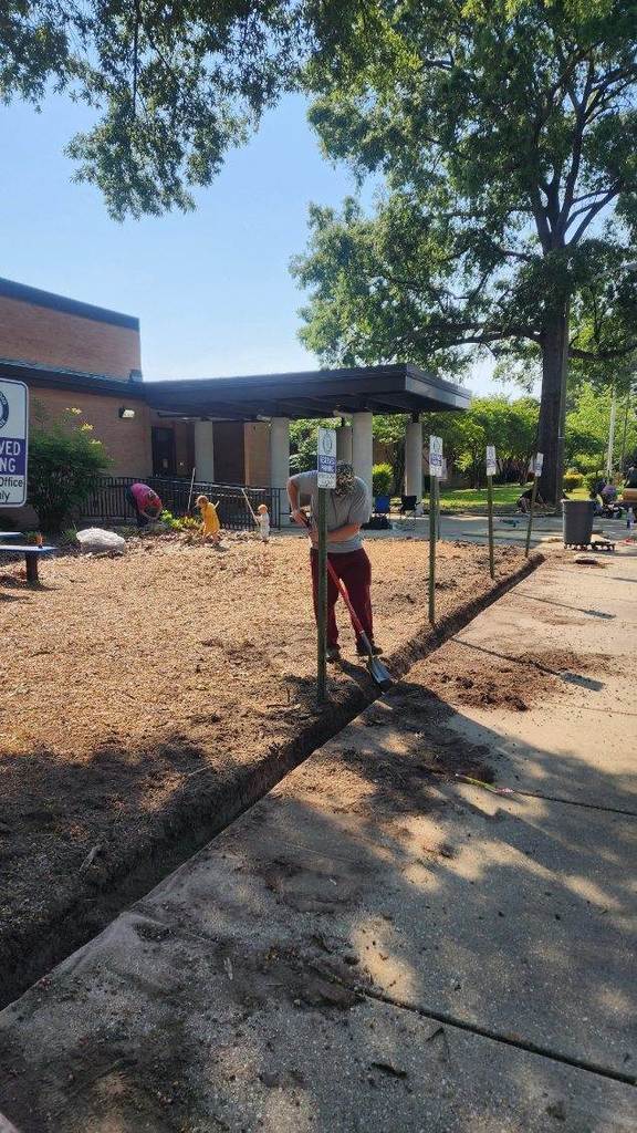 Cleaning up the mulch beds in the front of the building.