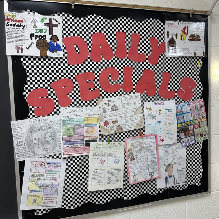 Handmade educational posters displayed on a checkered background. The posters use colorful drawings, diagrams, and handwritten text to profile historical figures and organization goals, featuring names like Richard Allen and Absalom Jones.