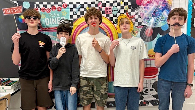 students posing with 1950s themed items