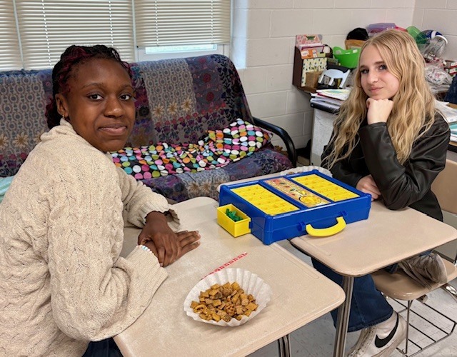 students enjoying snacks and playing a game from teh 1950s