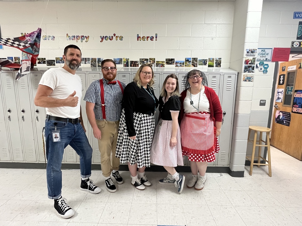 Teachers posing in the 1950s themed outfits