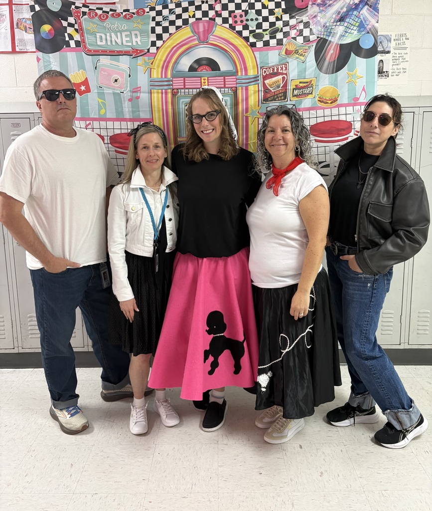 Teachers posing with their 1950s themed outfits