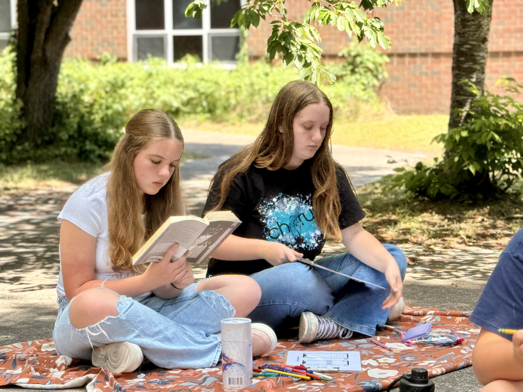 students enjoying nice weather while reading
