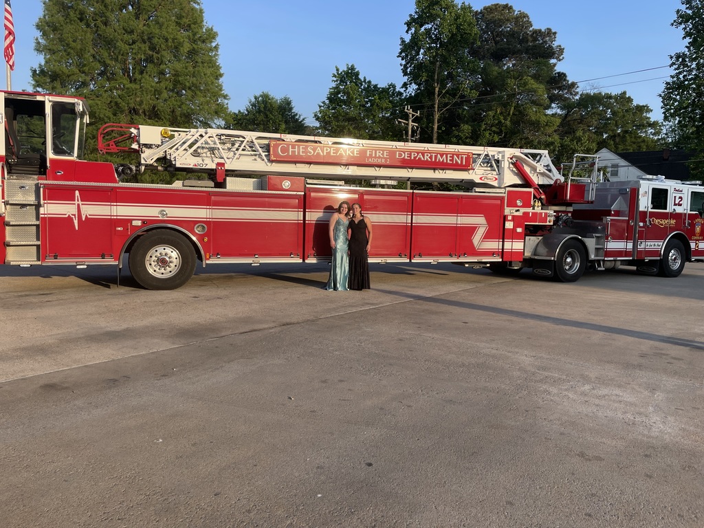 fire fighting students go to Prom and pose In front of a fire truck