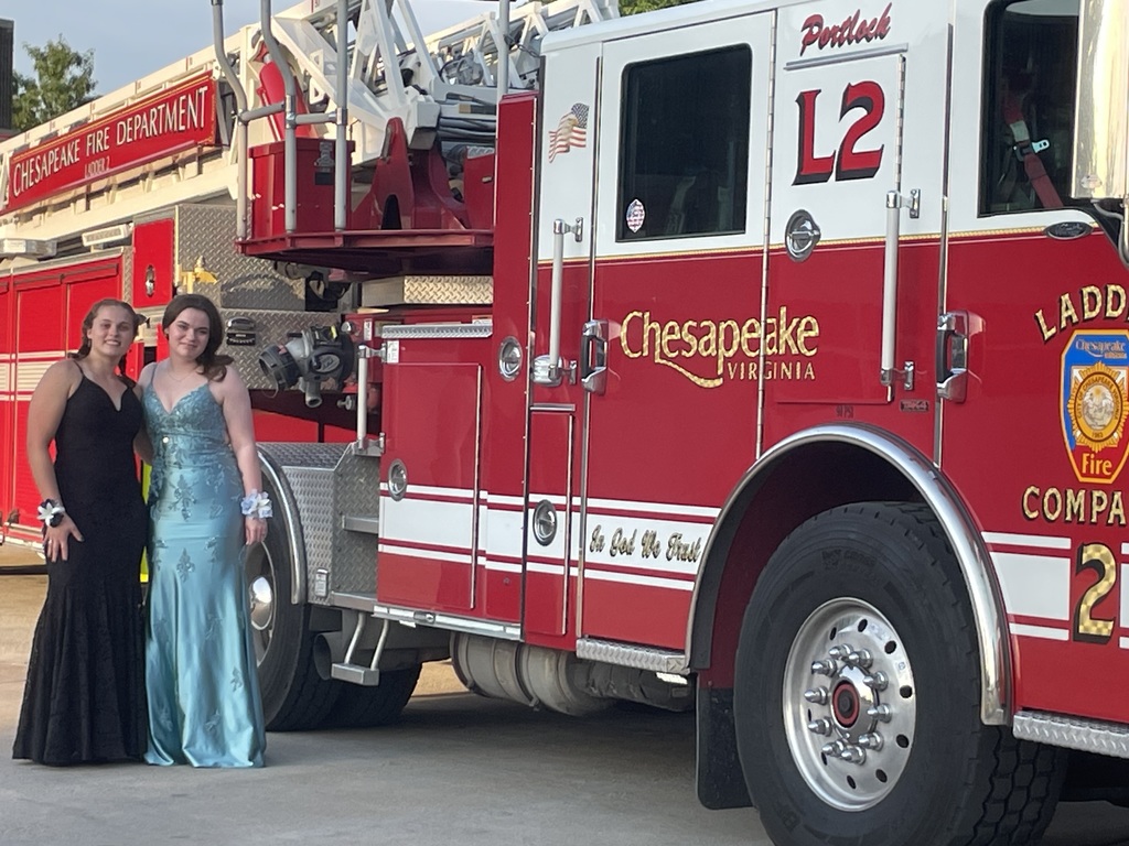 fire fighting students go to Prom and pose In front of a fire truck