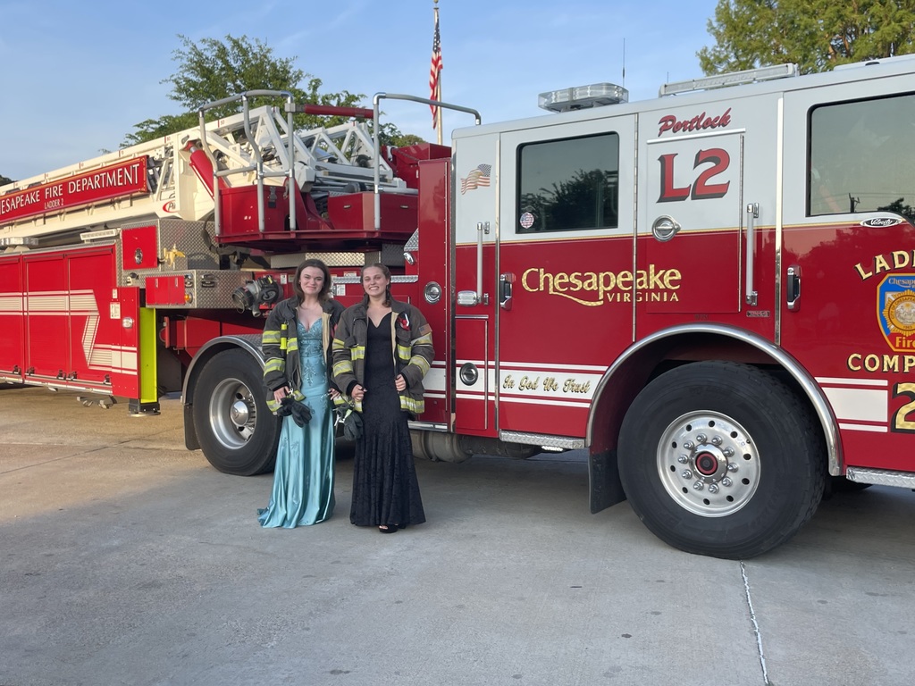 fire fighting students go to Prom and pose In front of a fire truck