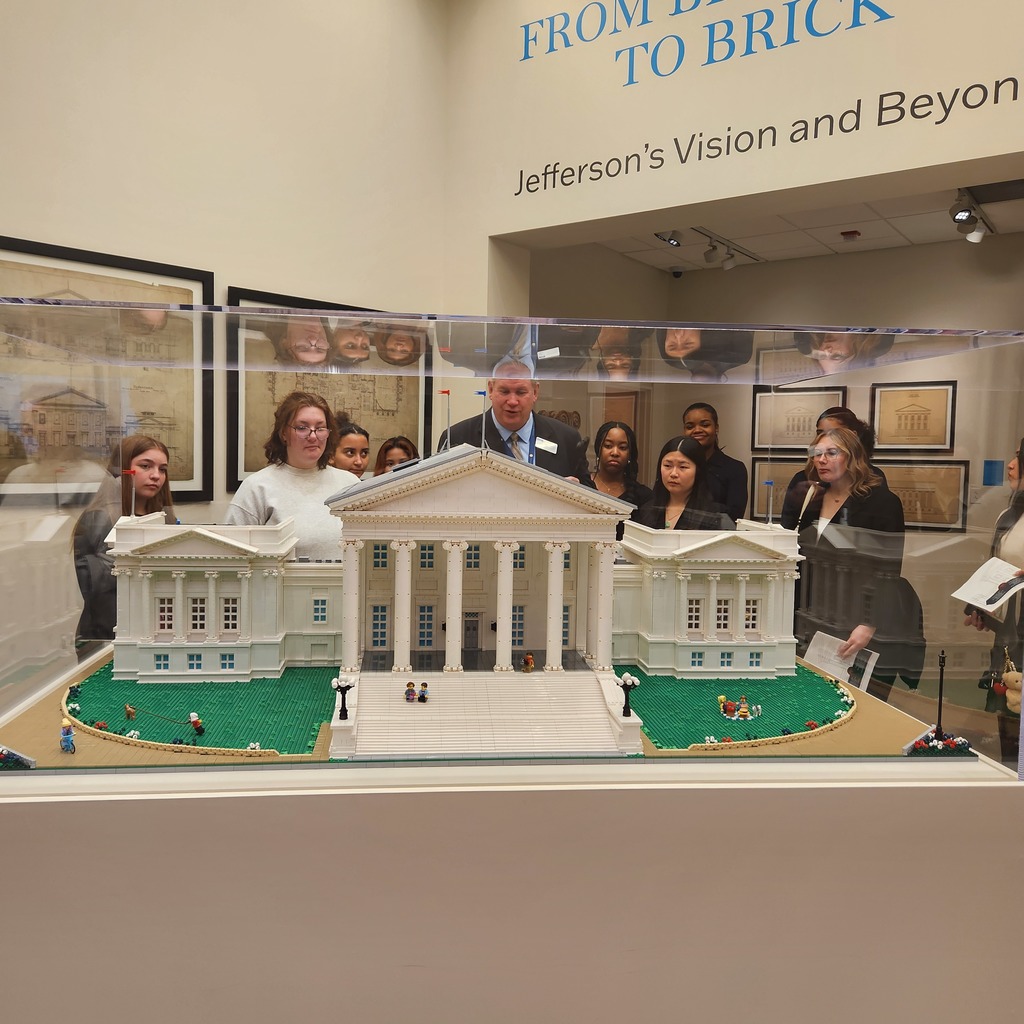 Young ladies gathered around a replica of the Capital Building