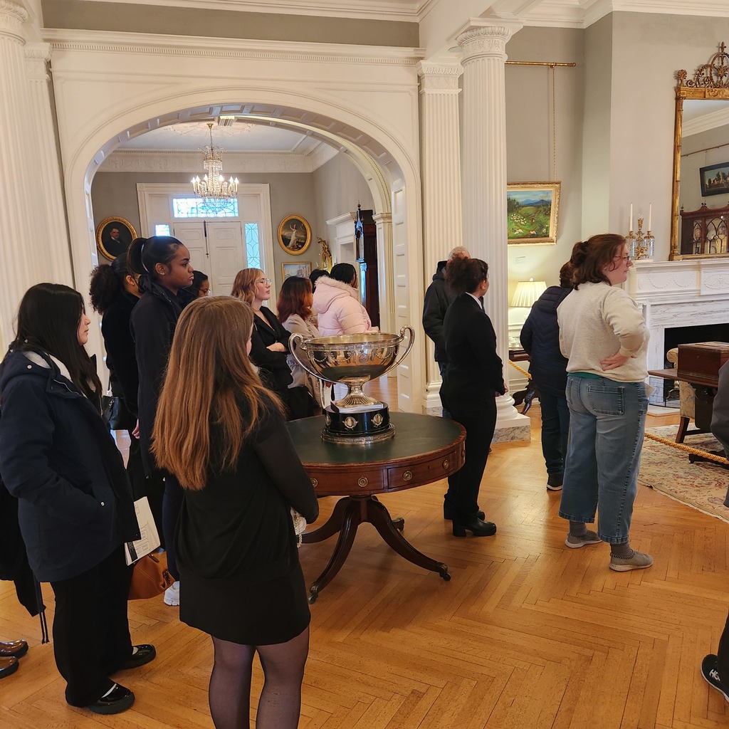 Young ladies being shown around the inside of the Governor's mansion