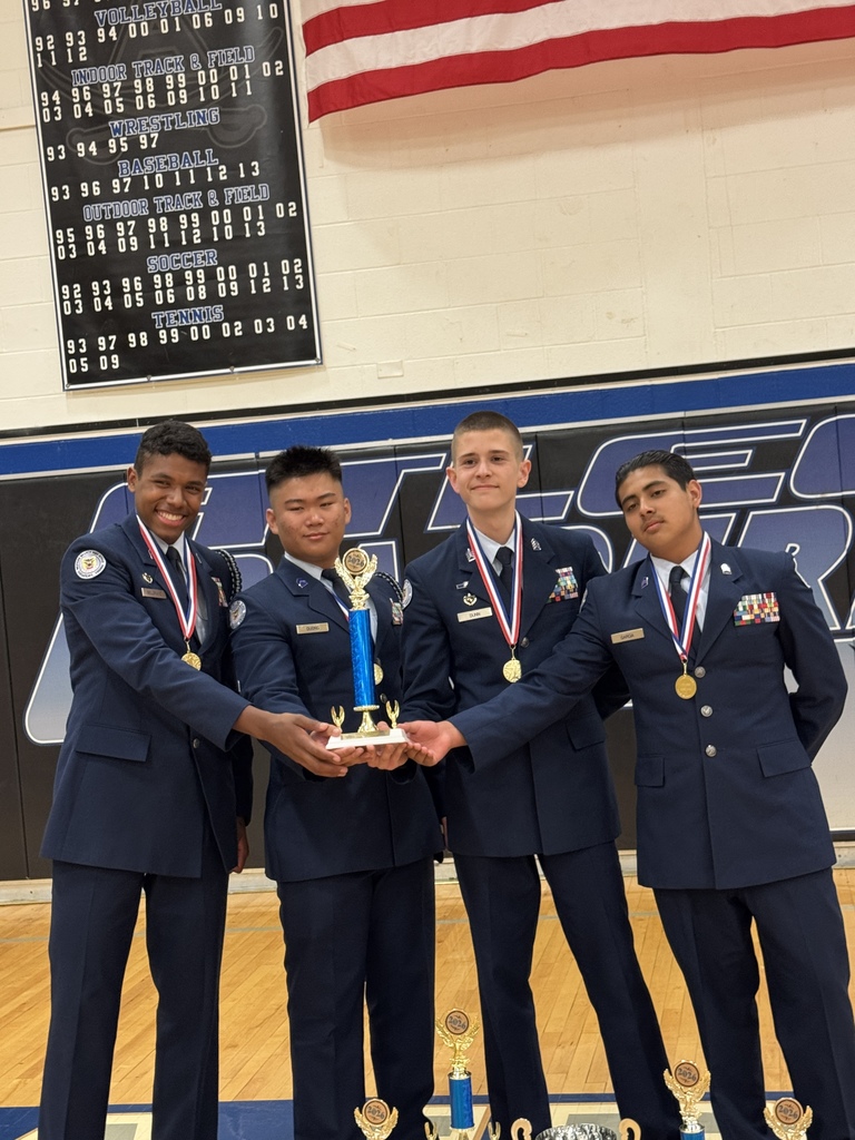 Air Force Junior ROTC cadets smiling and holding their trophy after the State Drill Championships