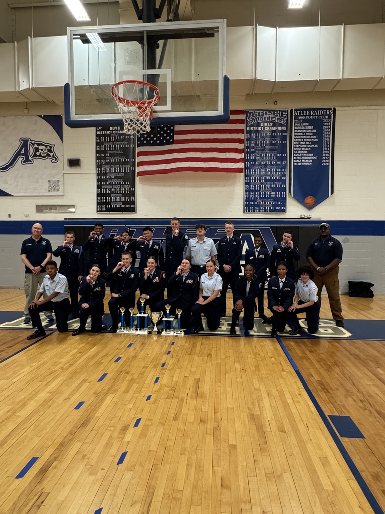 Air Force Junior ROTC cadets smiling and biting their medals after the State Drill Championships
