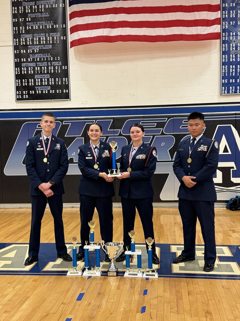 Air Force Junior ROTC cadets smiling and holding their trophies after the State Drill Championships