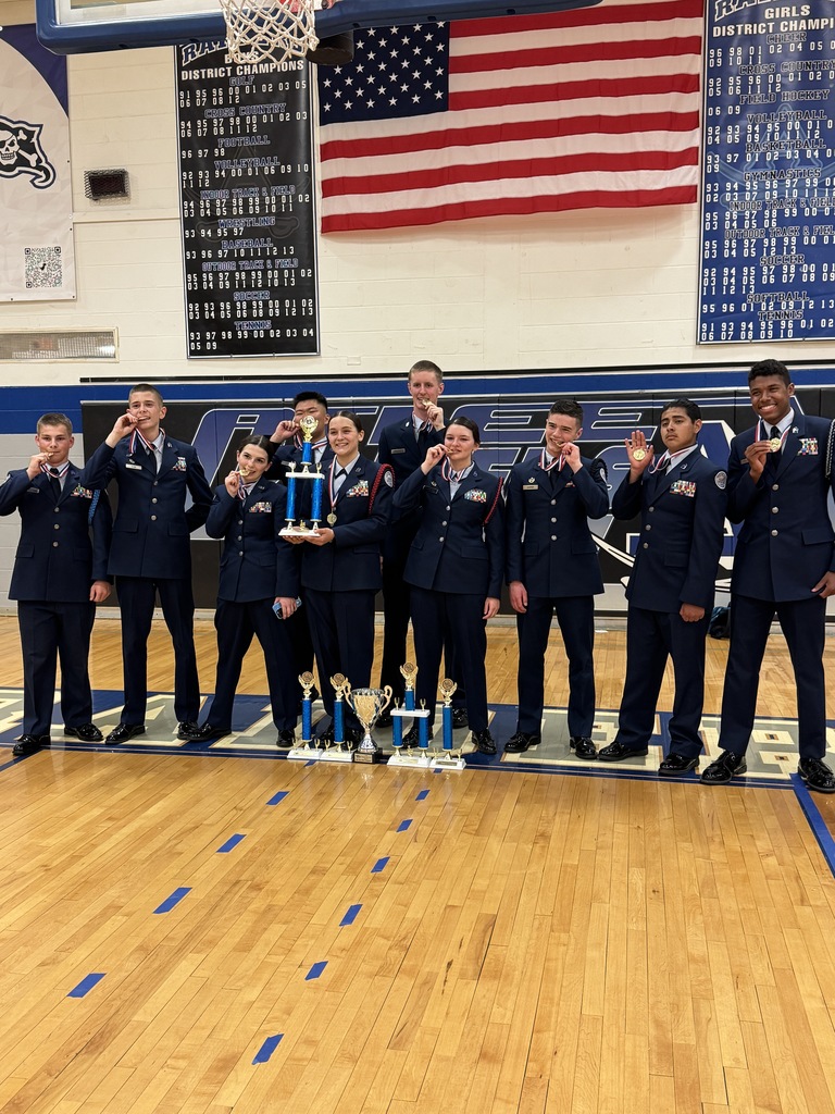 Air Force Junior ROTC cadets smiling and biting their medals after the State Drill Championships