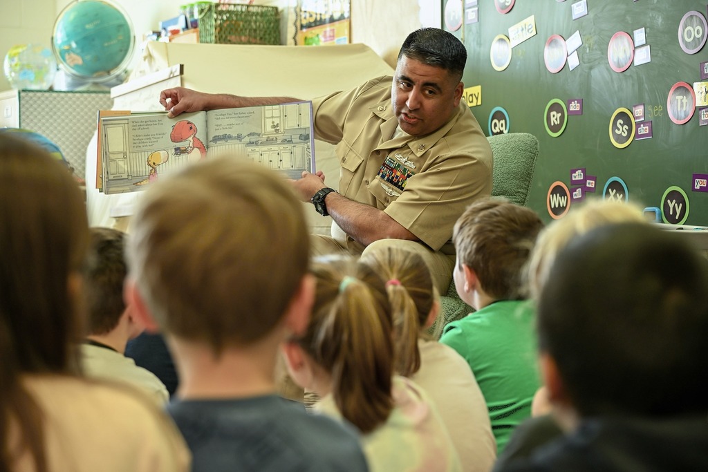 Military team for NSA proudly reads to  elementary students