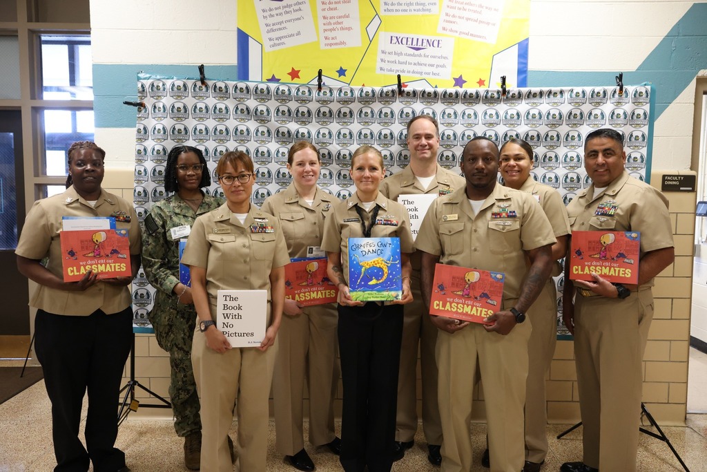 Military team for NSA proudly reads to  elementary students