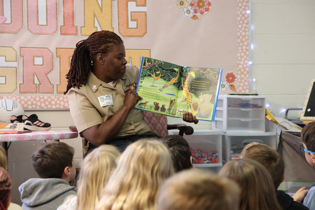 Military team for NSA proudly reads to  elementary students