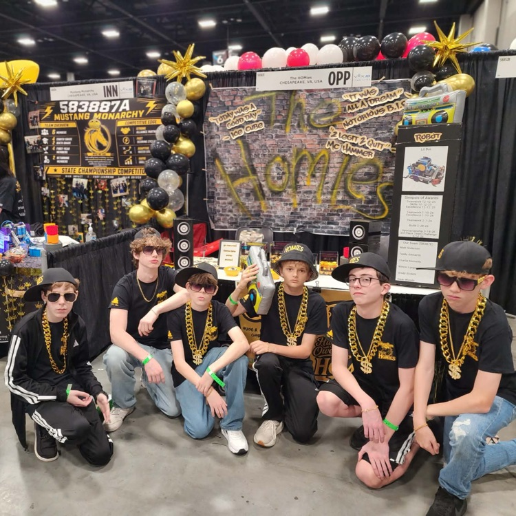 Group of robotic students posing in retro outfits at world championship