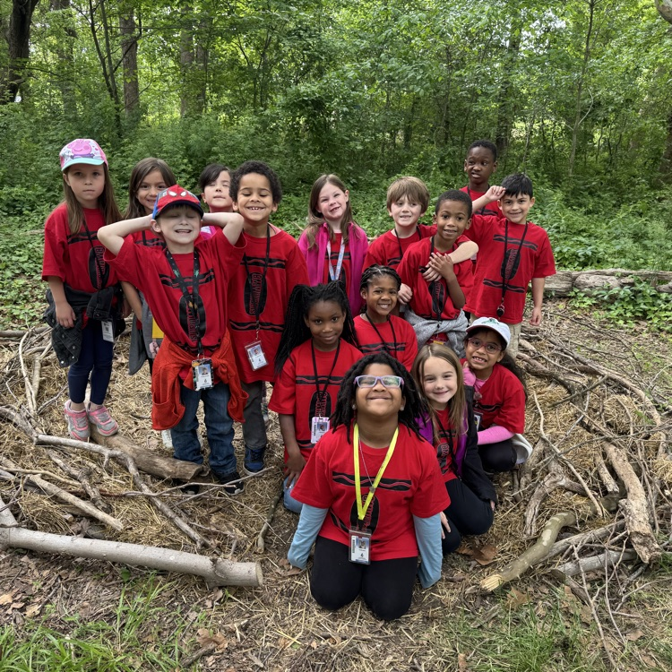 1st grade students excited posing in nature