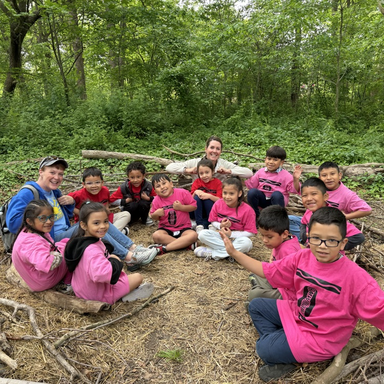 1st graders sitting in a circle in the park