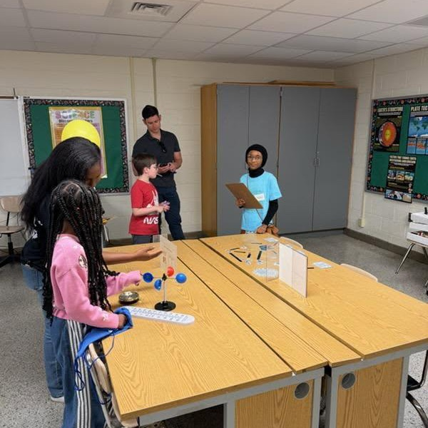 Families in the Science Lab with one of our Student Leadership Council members. 