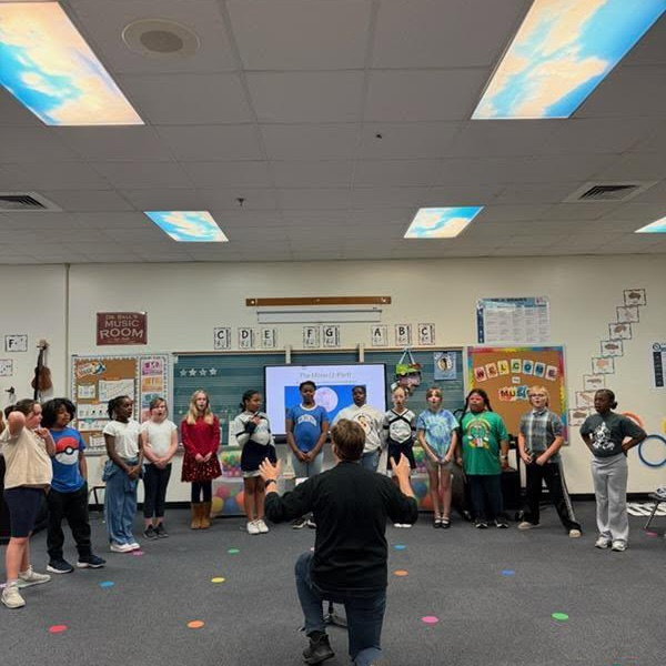 Dr. Ball with students in the music room. 