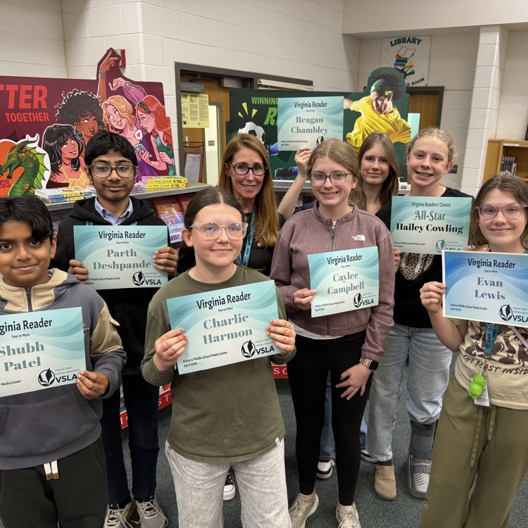 students proudly holding the certificates they earned 