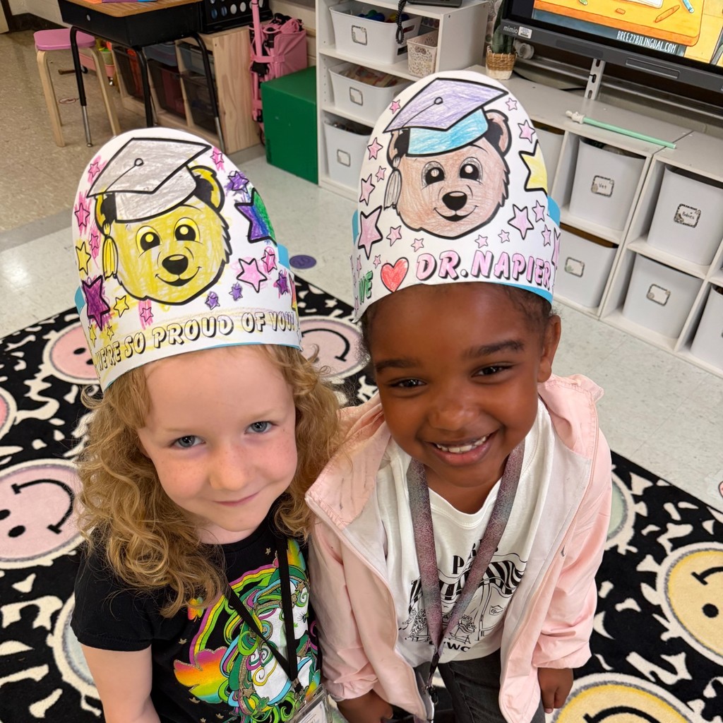 Students wearing colored hats with messages of congratulations for Dr. Napier
