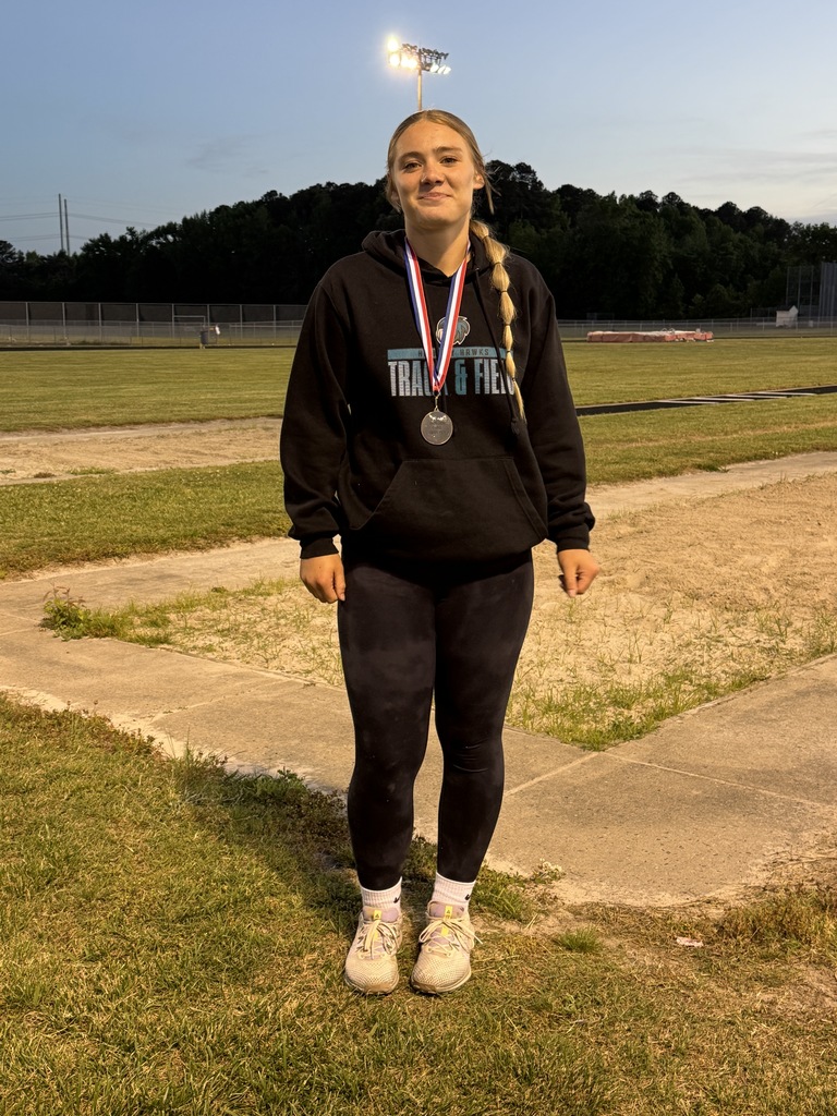 track student athlete proudly standing with their medal