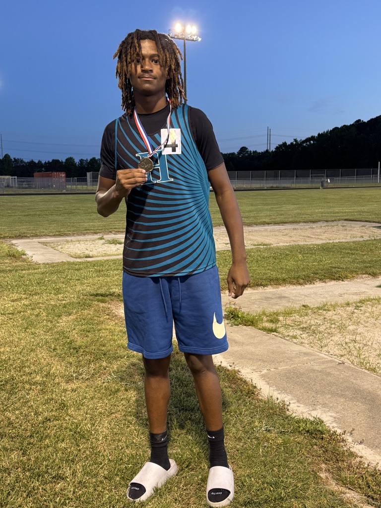 track student athlete proudly standing with their medal