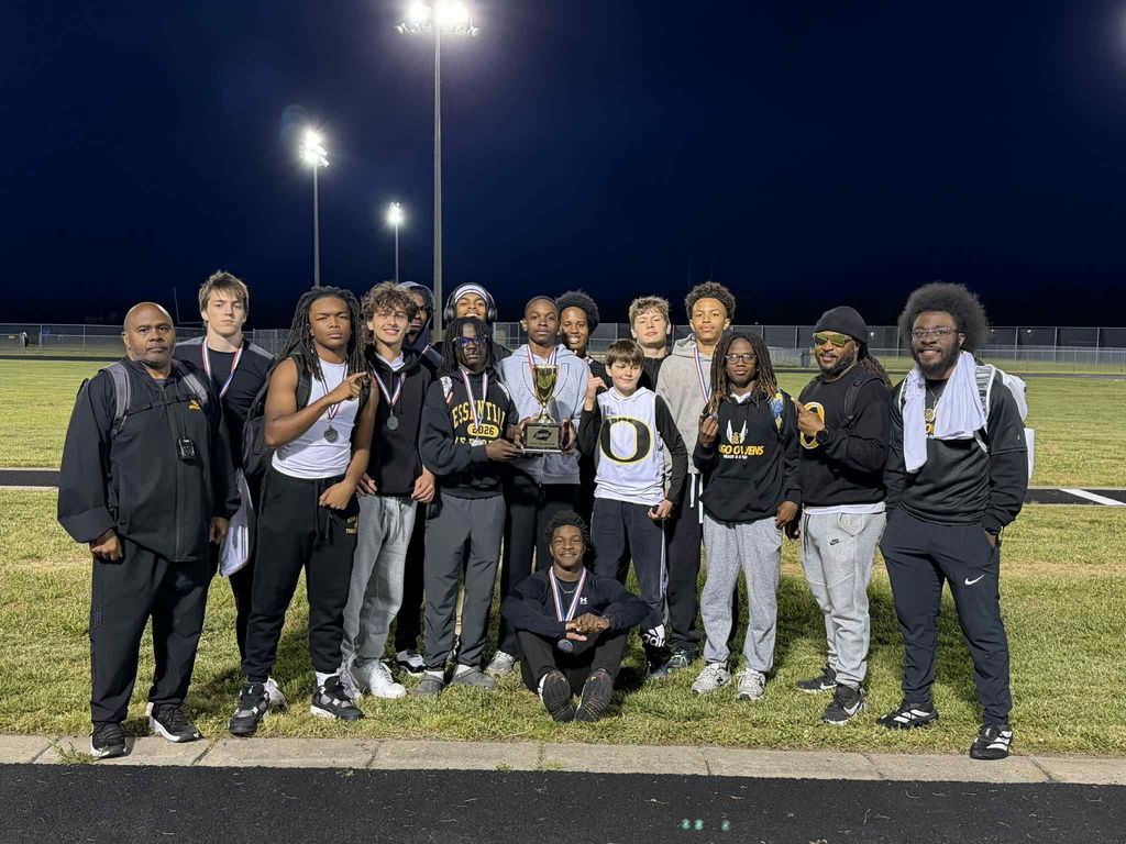 Boys track team standing on the field 